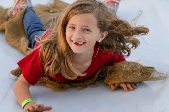 a little girl smiling at the camera