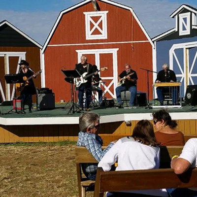 a group of people sitting in front of a house